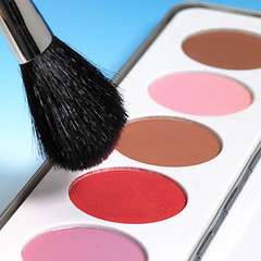 Image showing make-up colors and brush