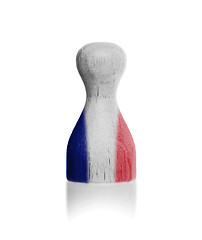 Image showing Wooden pawn with a painting of a flag