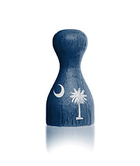 Image showing Wooden pawn with a painting of a flag