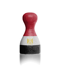 Image showing Wooden pawn with a painting of a flag