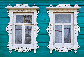 Image showing Wooden platbands on two window of an village house