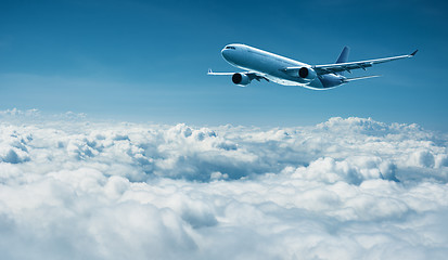 Image showing Airplane flies above clouds - air travel