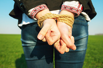 Image showing Hands tied up with rope