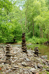 Image showing Stones pyramid near small river