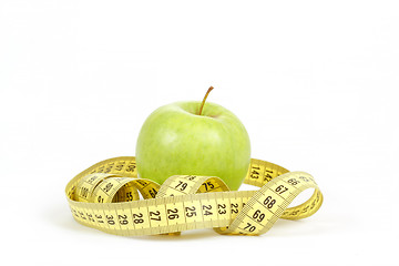 Image showing Green apple and measuring tape isolated on white background