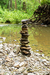 Image showing Stones pyramid near small river