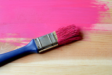 Image showing Half-painted wood with paintbrush