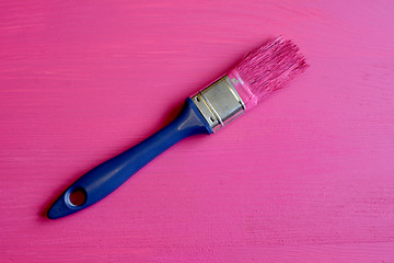 Image showing Dirty paintbrush on painted pine