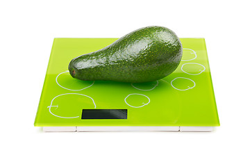 Image showing Green avocado on square scales