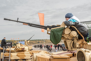 Image showing Boy gets acquainted with machine gun