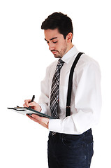 Image showing Man writing on clipboard.