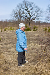 Image showing One elderly woman in a spring forest