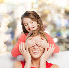 Image showing smiling mother and daughter making a joke