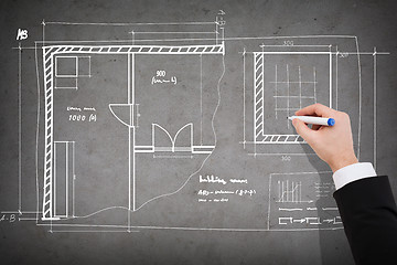 Image showing close up of businessman drawing blueprint