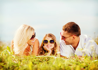 Image showing happy family with blue sky and green grass