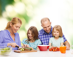 Image showing happy family with two kids making dinner at home