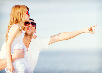 Image showing happy father and child in sunglasses over blue sky