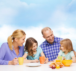 Image showing happy family with two kids with having breakfast