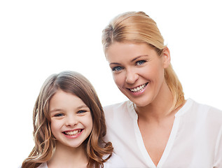 Image showing smiling mother and little girl at home
