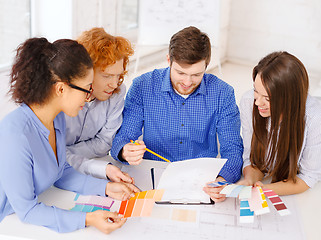 Image showing team with color samples and blueprint at office