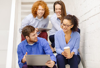 Image showing team with laptop and tablet pc on staircase