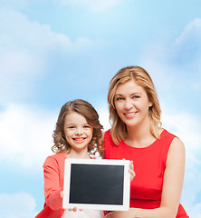 Image showing smiling mother and daughter with tablet pc