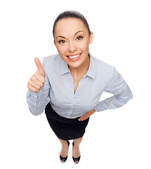 Image showing smiling asian businesswoman showing thumbs up