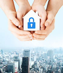 Image showing hands holding paper house with lock