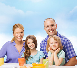 Image showing happy family with two kids with having breakfast