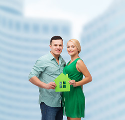 Image showing smiling couple holding green paper house