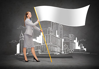 Image showing smiling woman holding flagpole with white flag