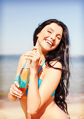 Image showing girl with bottle of drink on the beach