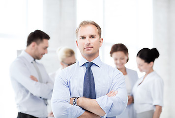 Image showing handsome businessman with team in office