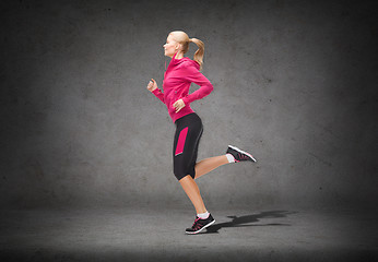 Image showing sporty woman running or jumping