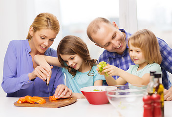 Image showing happy family with two kids making dinner at home