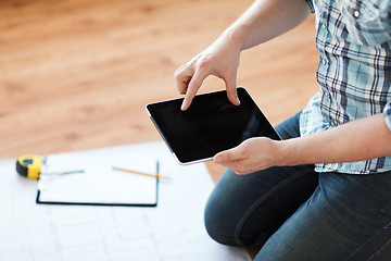 Image showing male with tablet pc, blueprint and measuring tape