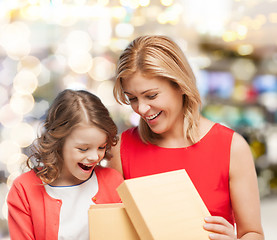 Image showing smiling mother and daughter opening gift box