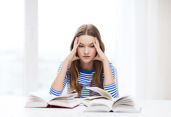 Image showing stressed student girl with books