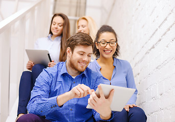 Image showing team with tablet pc computer sitting on staircase