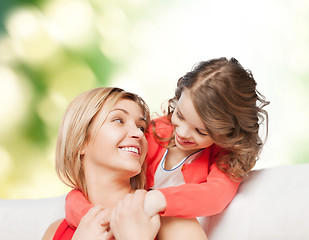 Image showing smiling mother and daughter hugging