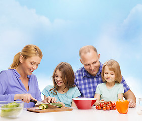 Image showing happy family with two kids making dinner at home