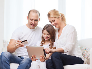 Image showing parents and girl with tablet pc and credit card