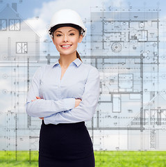 Image showing friendly smiling businesswoman in white helmet