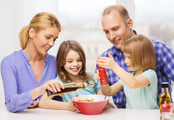 Image showing happy family with two kids eating at home