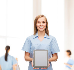 Image showing smiling female doctor or nurse with tablet pc