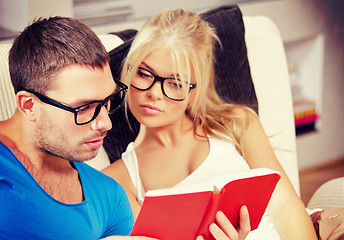 Image showing couple at home with book