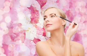 Image showing beautiful woman with makeup brush