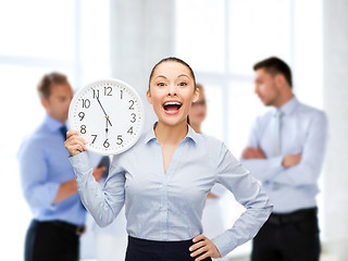 Image showing attractive businesswoman with wall clock