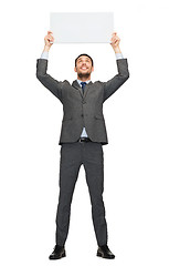 Image showing smiling businessman with white blank board