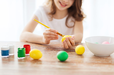 Image showing close up of girl coloring eggs for easter